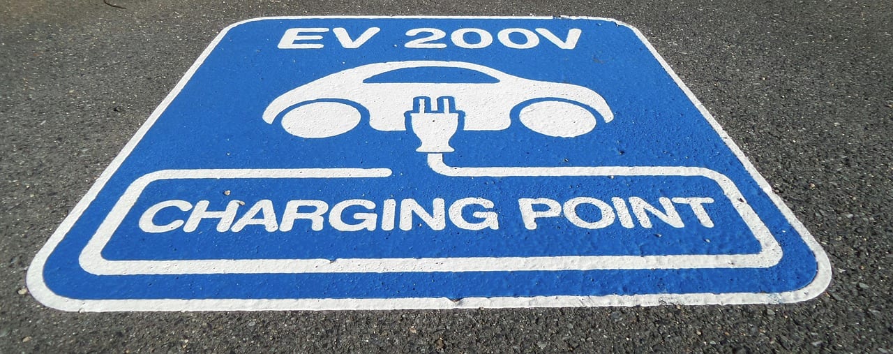 An electric vehicle charging bay painted in blue and white