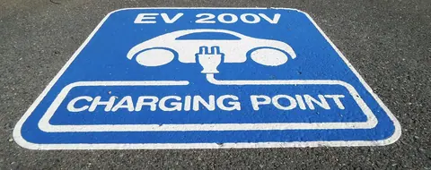 An electric vehicle charging bay painted in blue and white