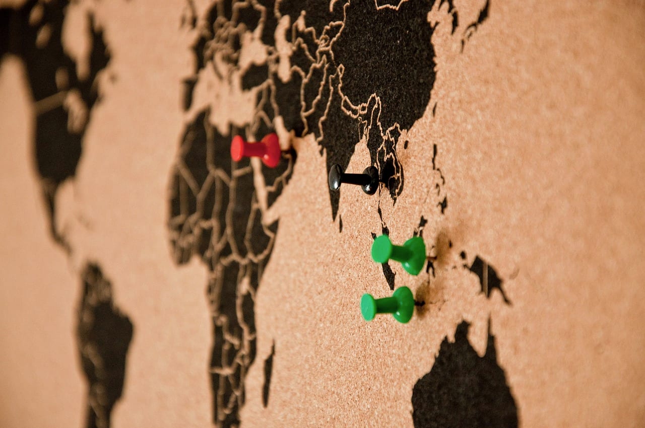 Pins pushed into a cork map of the world