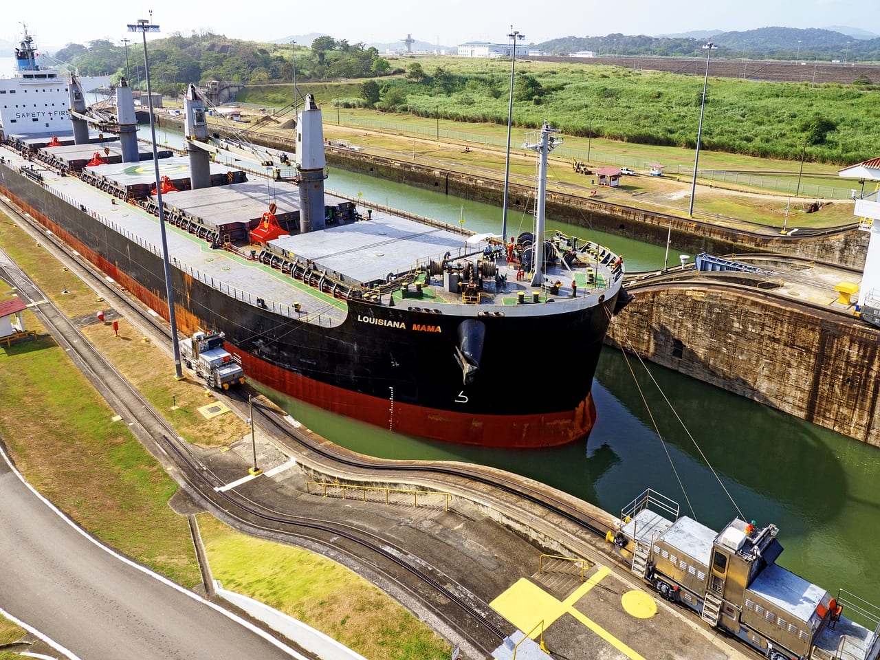 A bulk carrier being guided through canal locks