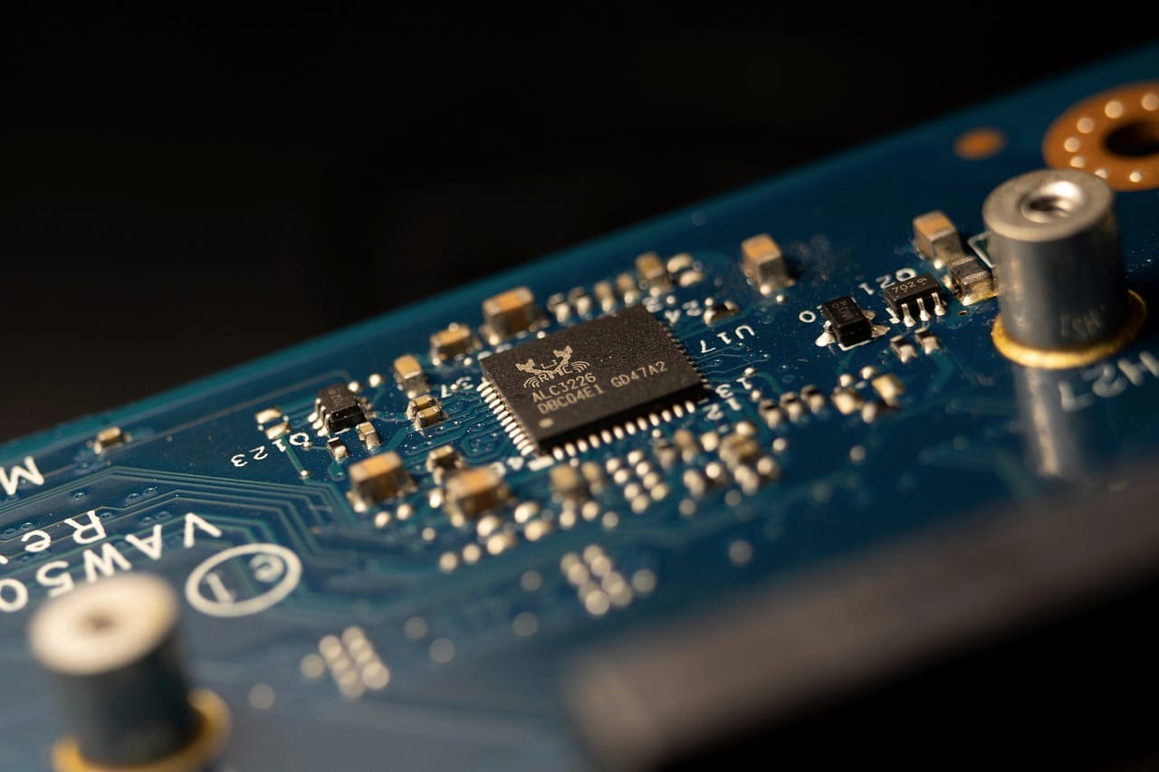 A circuit board in close-up, dark blue with gold contacts